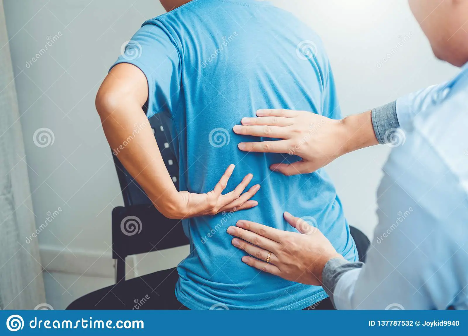 Doctor Consulting With Patient Back Problems Physical ...