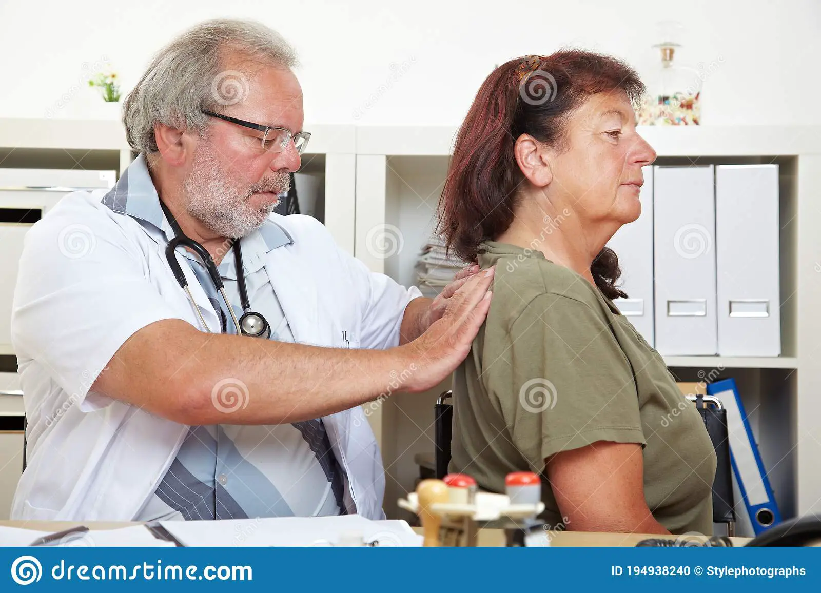 Doctor Treats Patient With Back Pain Stock Photo