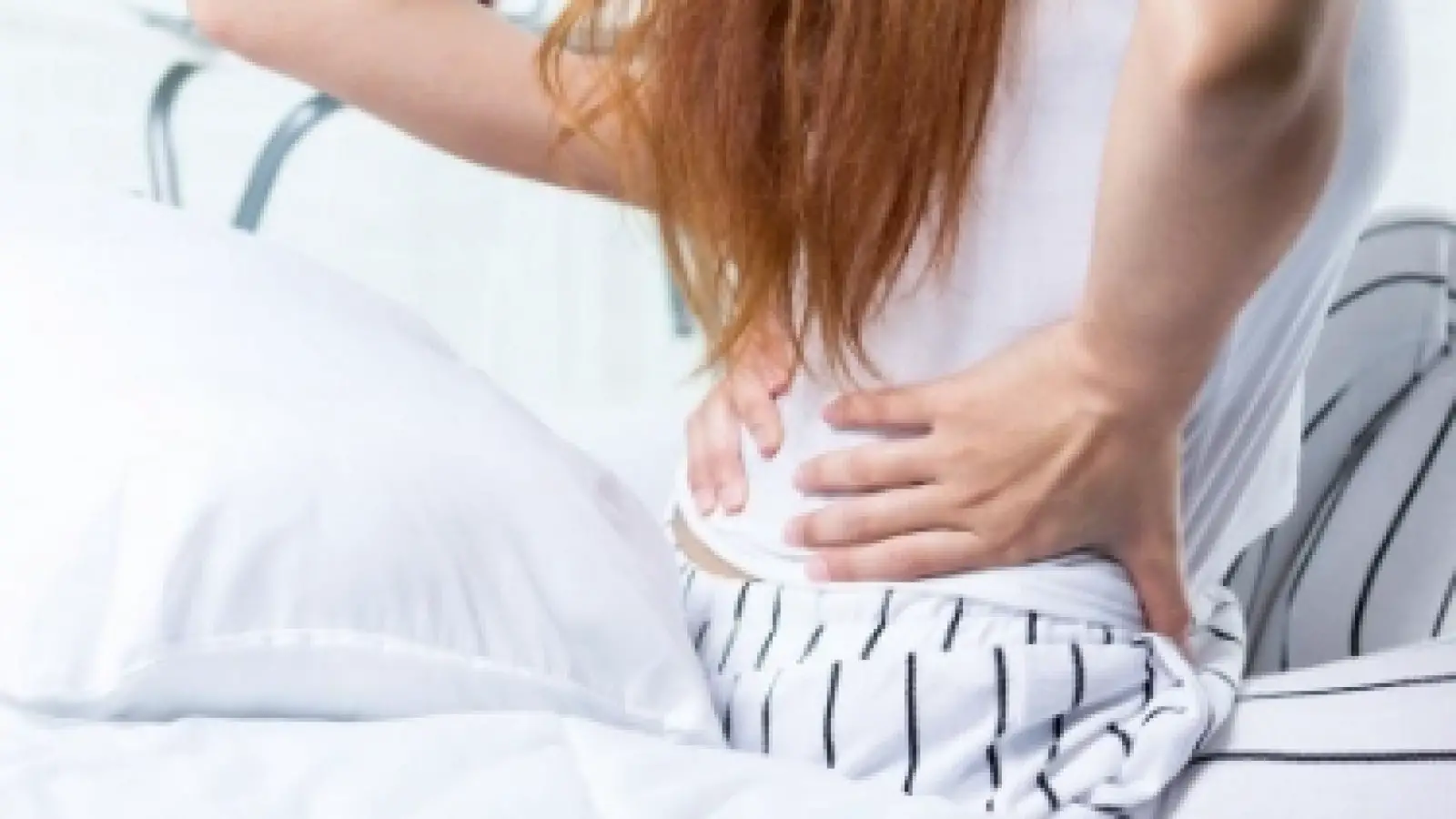 How should you sleep if you have lower back pain?